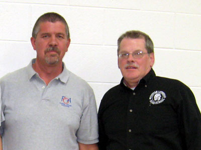 John Eggert of Michigan Lutheran High School receives the 2008-09 Herb Quade award from FOA President Bruce Arter.